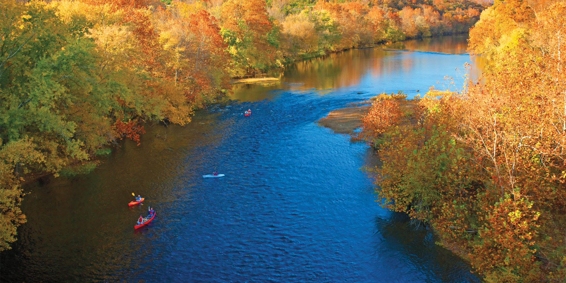 aerial view of kayaks and canoes on a fall float along the Upper James River